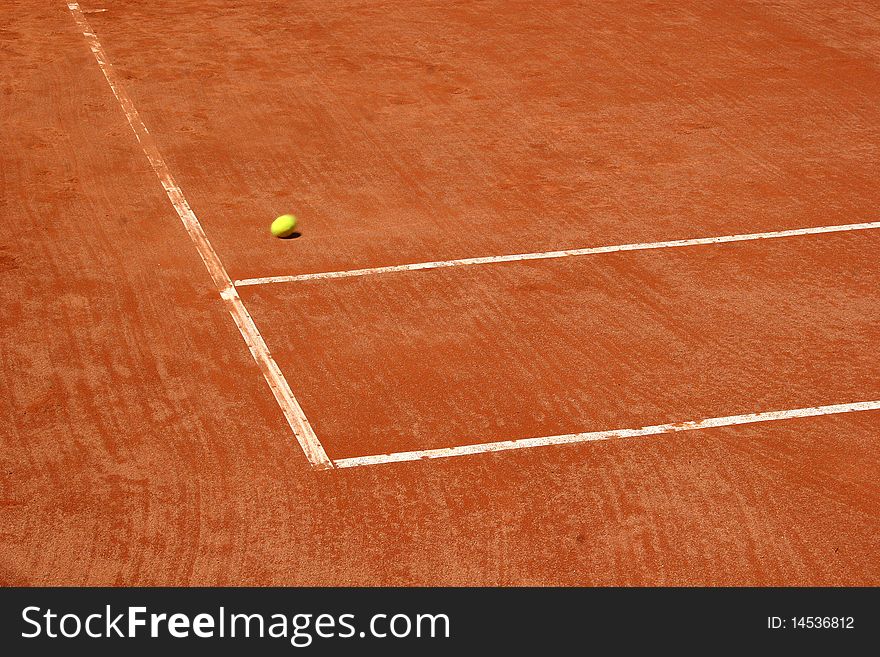 Tennis court with blurred ball on the move