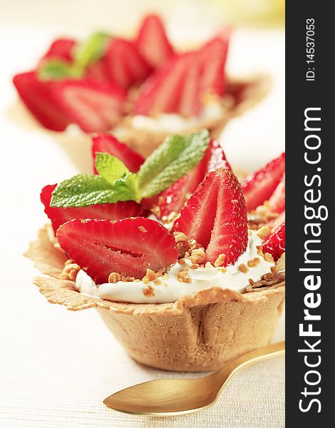 Small tarts with cream and fresh strawberries. Small tarts with cream and fresh strawberries