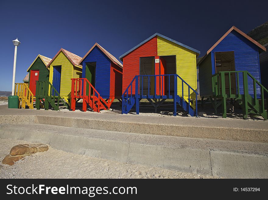 Colourful wooden changing cabins at the beach. St. James beach, Cape Town. Colourful wooden changing cabins at the beach. St. James beach, Cape Town.