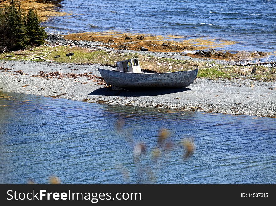 Abandoned boat washed up on a beach. Abandoned boat washed up on a beach