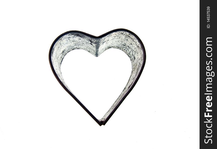 A vintage heart shaped sugar dough cookie cutter on an isolated white background. A vintage heart shaped sugar dough cookie cutter on an isolated white background.