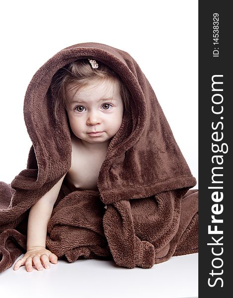 Beautiful baby under a brown towel