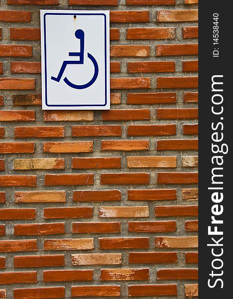 Brick Wall With Blue And White Sign