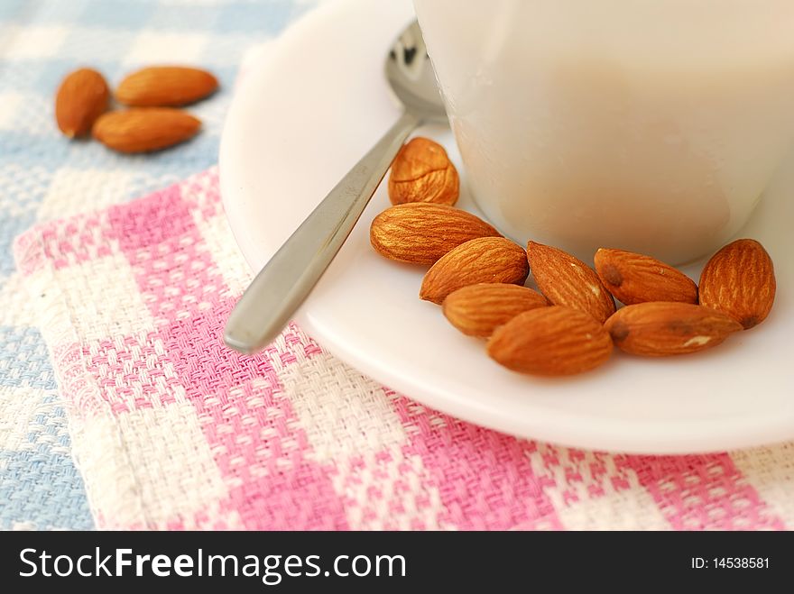 Closeup of almonds beside beverage