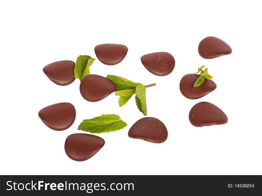 Chocolate petals with mint leaves isolated on white