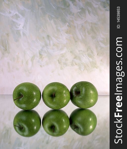 Three green apples isolated on mirror