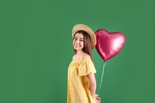 Portrait Of Young Woman With Heart Shaped Balloon On Color Background Stock Image