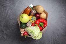Paper Package With Fresh Vegetables, Apple And Bottle Of Juice On Dark Background Stock Photos Paper Package With Fresh Vegetables, Apple And Bottle Of Juice On Dark Background Stock Photos