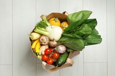 Paper Bag Full Of Fresh Vegetables On Light Background Stock Photography