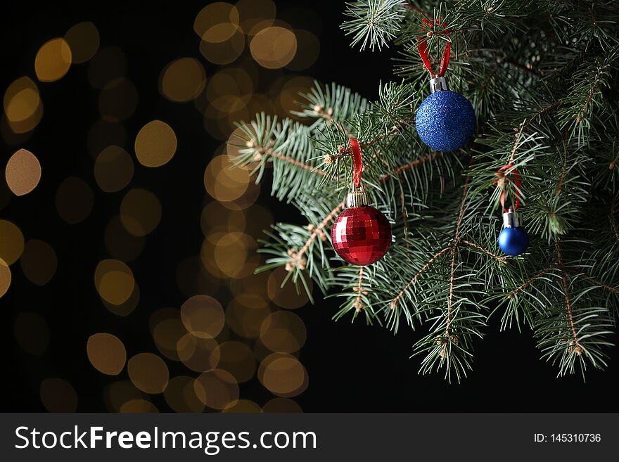 Beautifully decorated Christmas tree against blurred lights