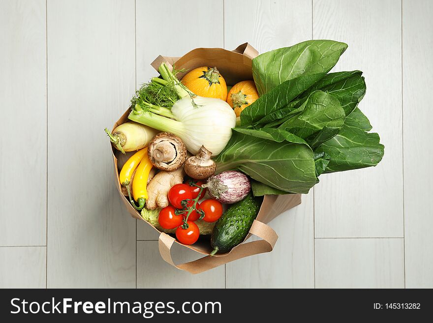 Paper Bag Full Of Fresh Vegetables On Light Background