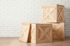 Free Wooden Crates On Floor Near Brick Wall Stock Image - 145379961