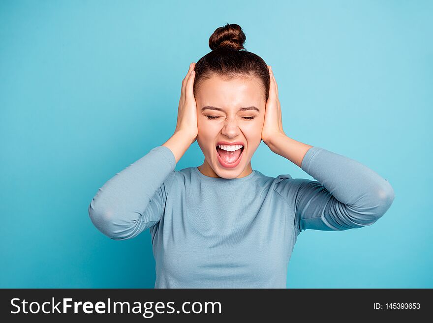 Close-up portrait of her she nice-looking attractive lovely winsome mad depressed girl shouting loudly closing ears isolated over bright vivid shine turquoise background.