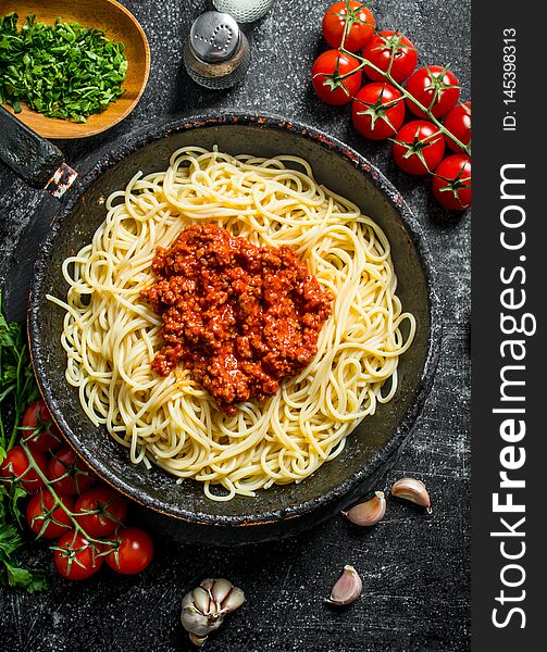 Spaghetti With Bolognese Sauce With Tomatoes And Chopped Greens In A Bowl