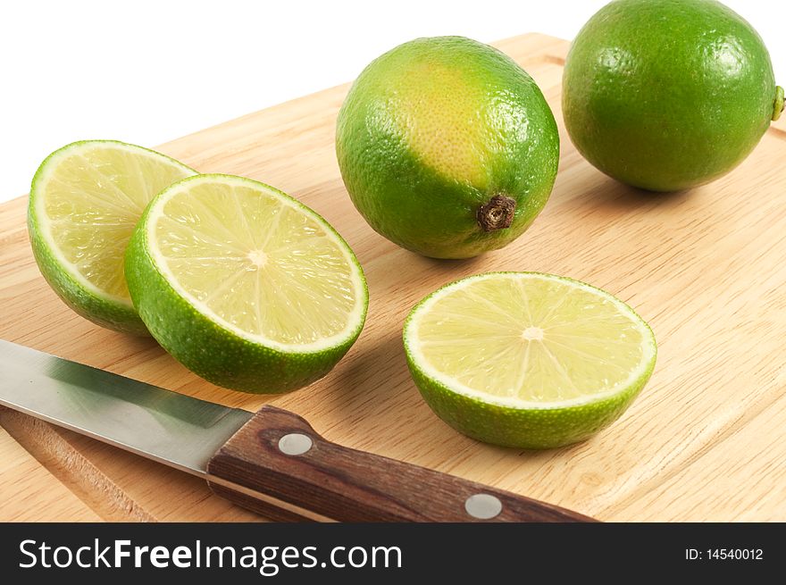 The limes and knife on the board