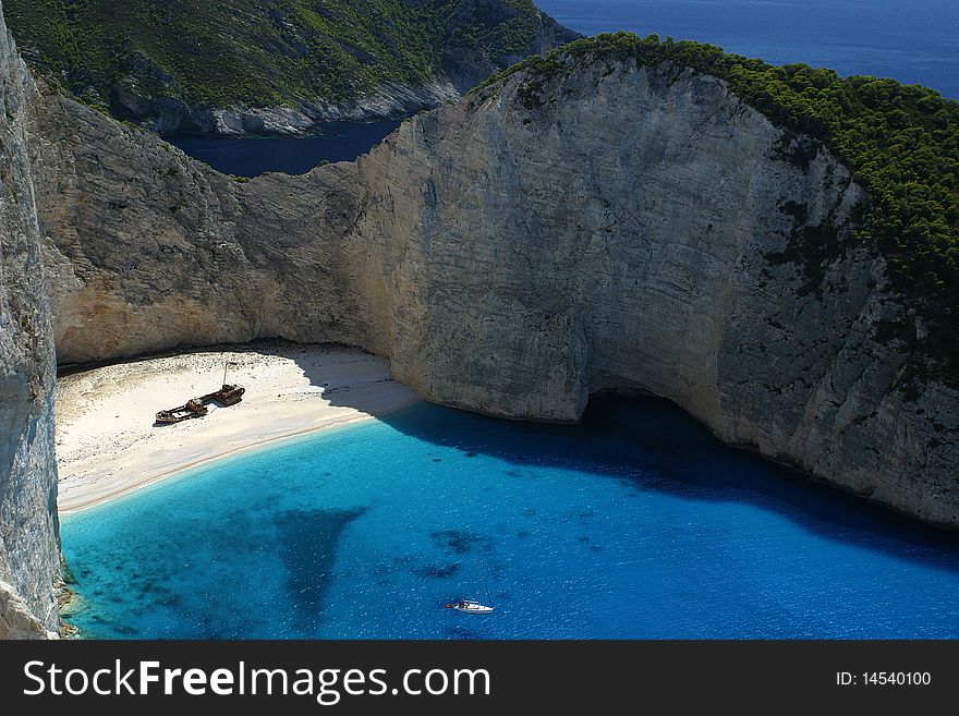 Deep bay with a beach with cliffs around in the island Zakynthos in Greece