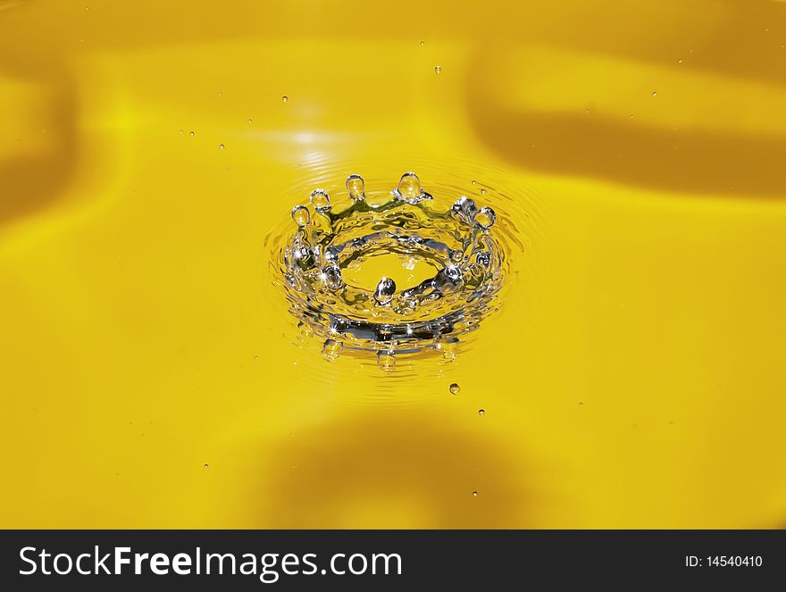 Splash of water on a yellow background. Splash of water on a yellow background