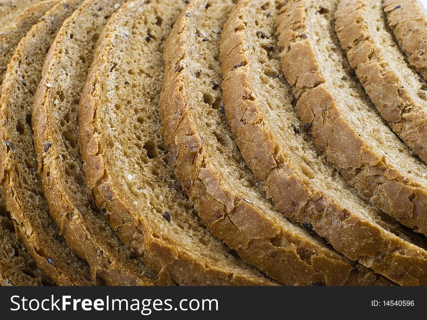 Sliced brown loaf bread background. Sliced brown loaf bread background