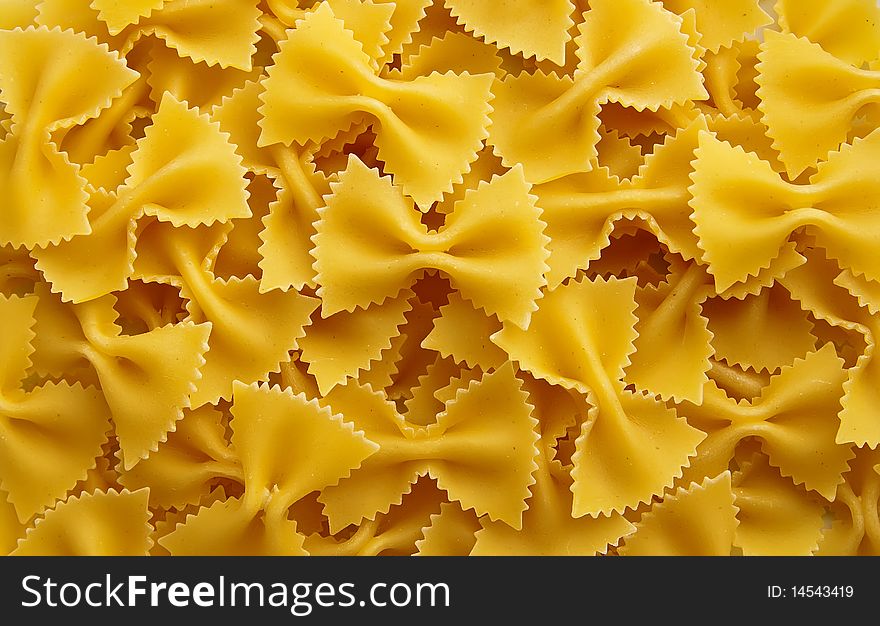 Close-up background made of raw farfalle pasta