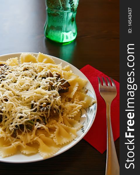 Italian lunch - farfalle pasta with sause made of eggplants and served with cheese