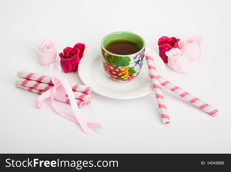 Cup of tea and cakes on grey background