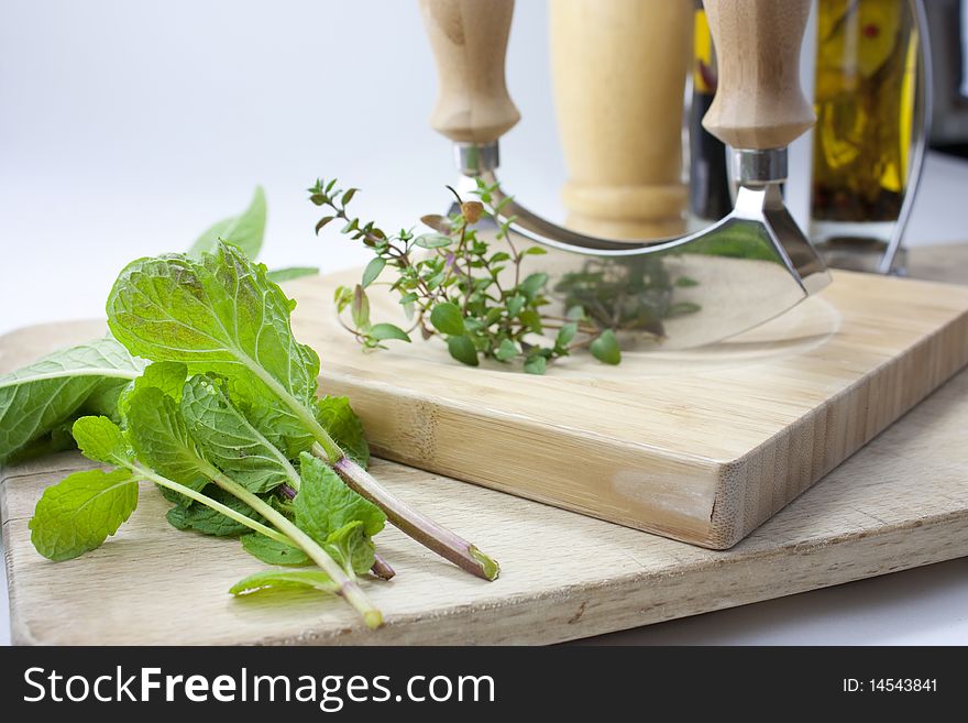 Studio kitchen shot of chopping a selection of herbs. Studio kitchen shot of chopping a selection of herbs