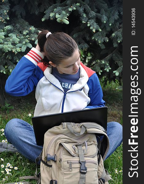 Young beautiful student learning outdoors with laptop. Young beautiful student learning outdoors with laptop