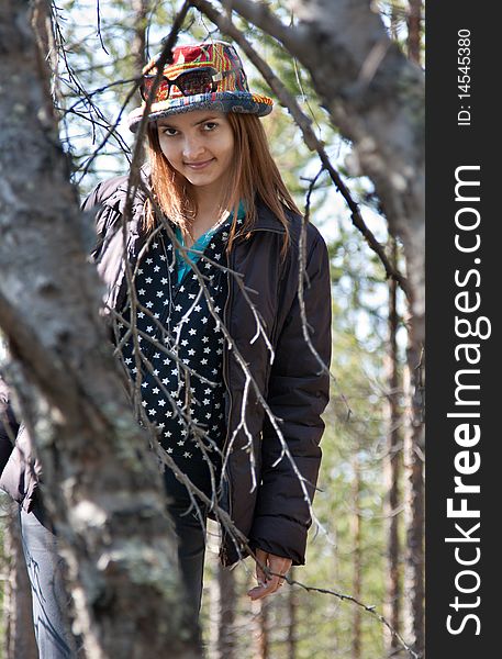 Girl in colour hat and sunglasses in wood