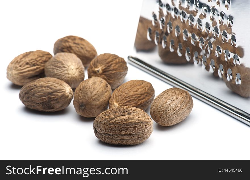 Nutmegs With A Grater On A White Background