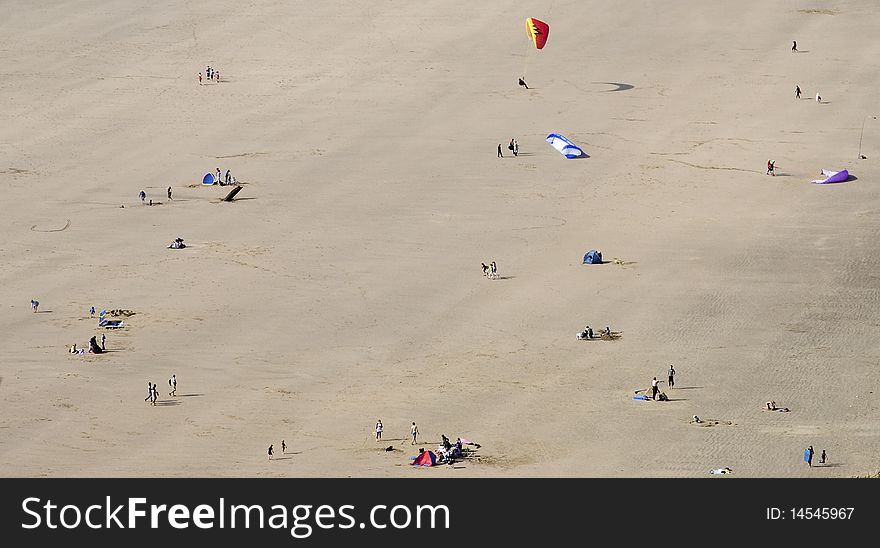 People undertaking various activities on a sandy beach, Rhossili, Wales. People undertaking various activities on a sandy beach, Rhossili, Wales.