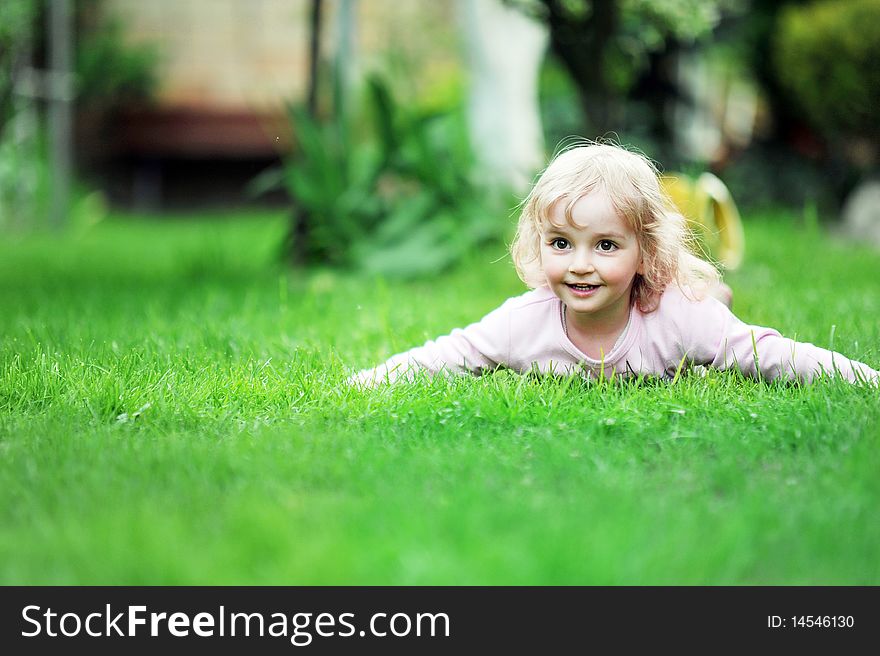 Little girl relaxing on grass