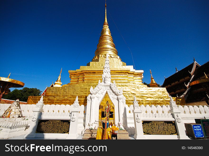 Golden temple stupa in Thailand against clear blue sky. Golden temple stupa in Thailand against clear blue sky