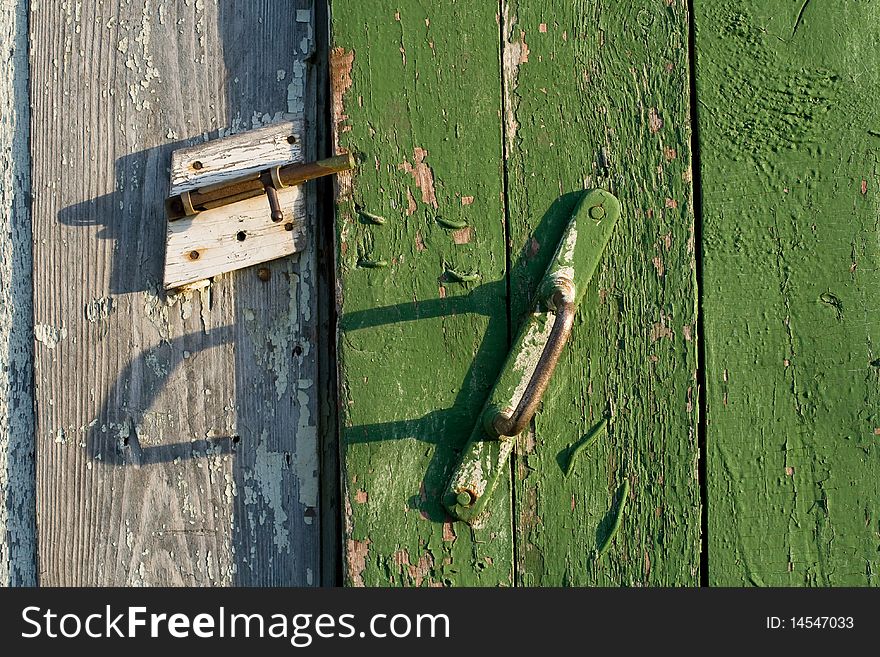 Boards of the old barn door, closed on the latch. Boards of the old barn door, closed on the latch