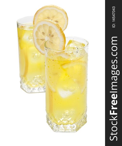 Two glasses of cold beverage with slices of lemon. Two glasses of cold beverage with slices of lemon