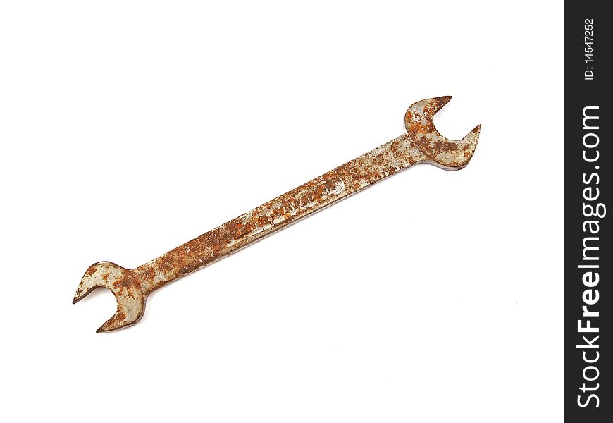 Rusty spanner on a plane white background.