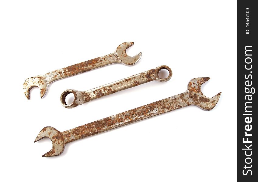 Rusty spanner on a plane white background.