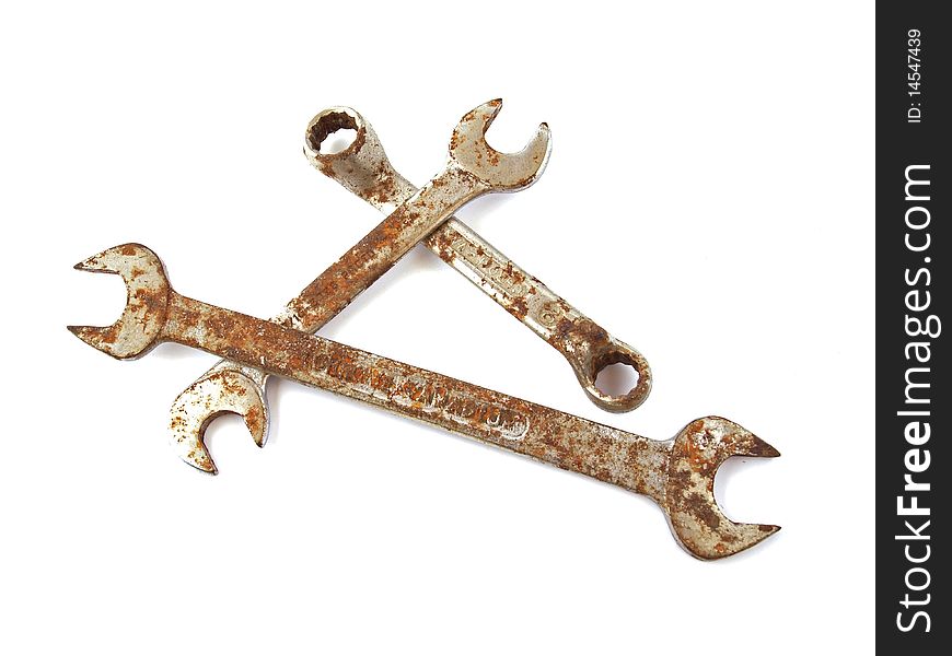 Rusty spanner on a plane white background.