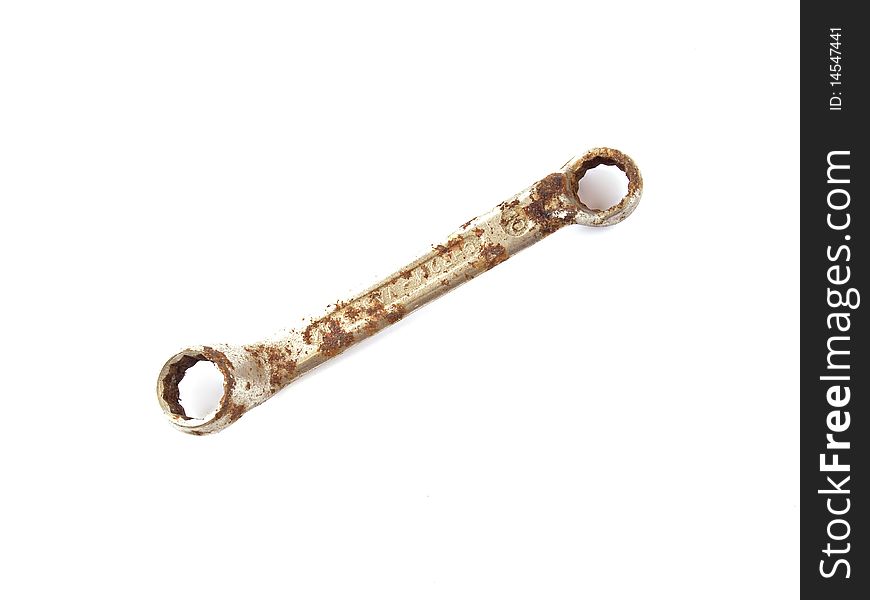 Rusty spanner on a plane white background.