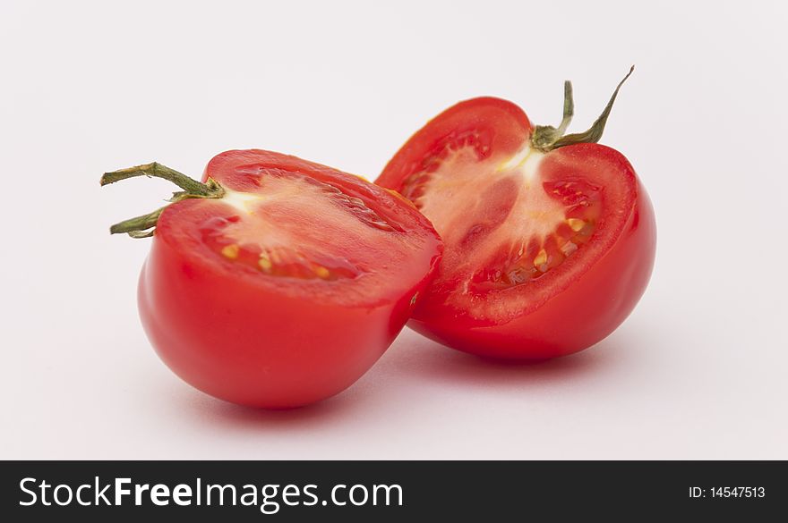 Halves of the Mature Tomato on the White Way with Breakage. Halves of the Mature Tomato on the White Way with Breakage