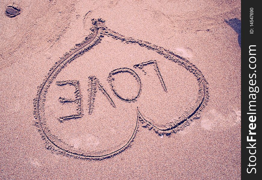 LOVE written on sandy beach