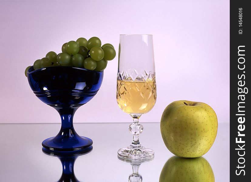 A glass of wine with fruits isolated on mirror. A glass of wine with fruits isolated on mirror