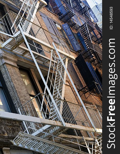 Perspective view of NYC building exterior with fire escapes