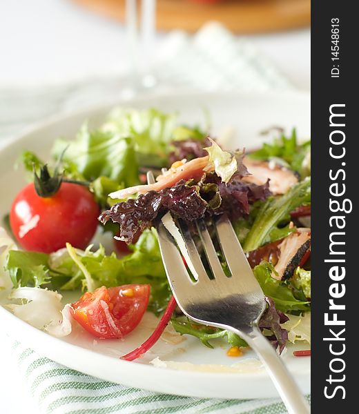 Very simple, yet elegant salad of mixed lettuce, cherry tomato,bacon and cheese