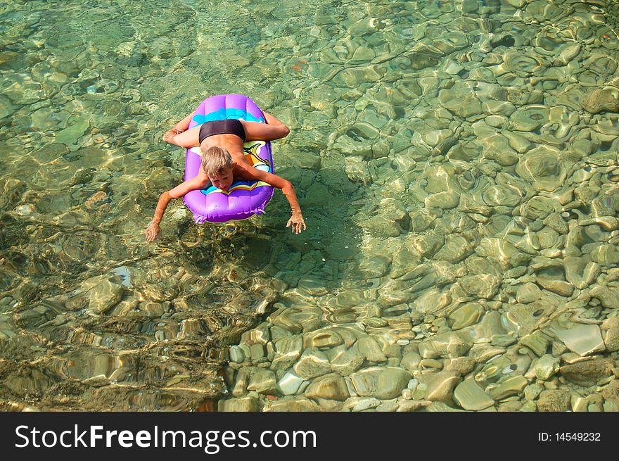 A kid is relaxing in Adriatic water of Croatia. A kid is relaxing in Adriatic water of Croatia