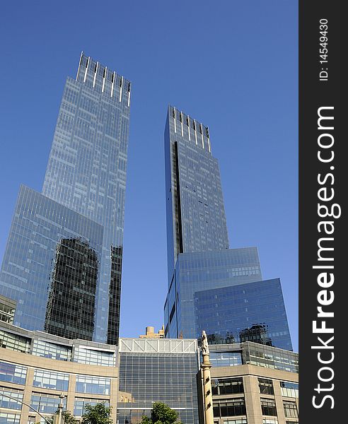 Towering skyscrapers and statue of Christopher Columbus at Columbus Circle in New York City.