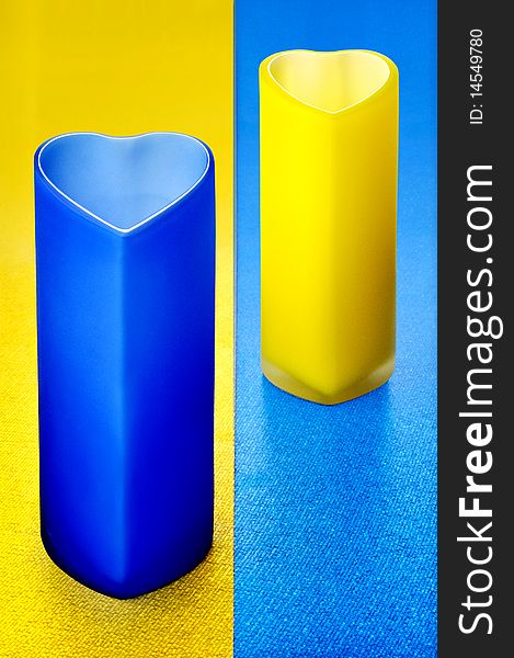 Colour glass bowls on yellow-blue background. Colour glass bowls on yellow-blue background