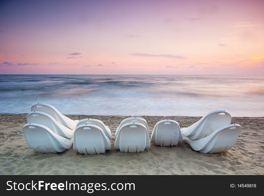 Beach chaise grouped at the end of the day in the italian coastline of Tuscany, Viareggio. Beach chaise grouped at the end of the day in the italian coastline of Tuscany, Viareggio