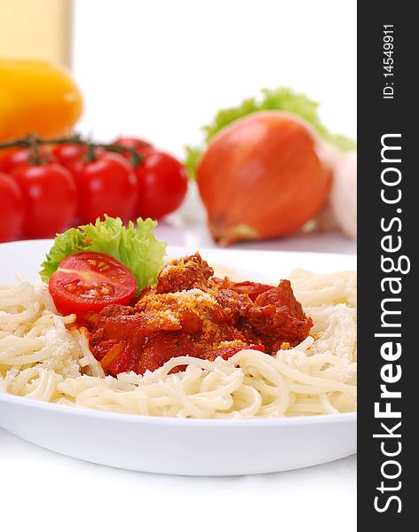 Closeup of spaghetti on white background with vegetables