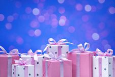 Stylish Boxes With Gifts In White Paper In The Stars, Decorated With Pink Satin Ribbon With Bows. Stock Photo Stylish Boxes With Gifts In White Paper In The Stars, Decorated With Pink Satin Ribbon With Bows. Stock Photo