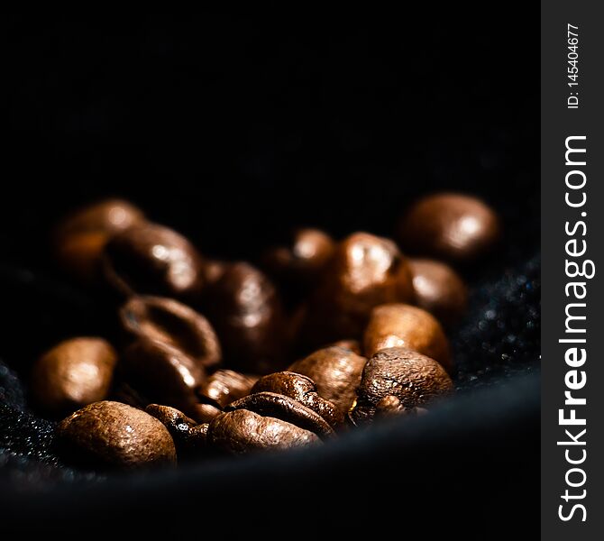 Dark background with grains of coffee